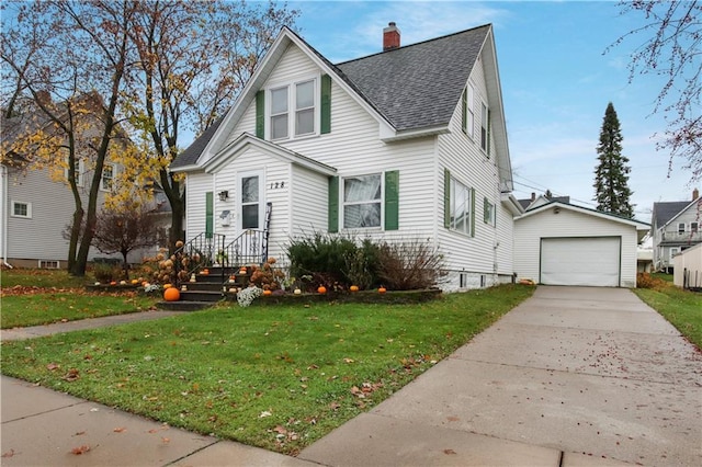 view of front facade featuring a garage, a front yard, and an outbuilding