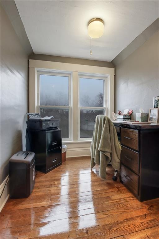 home office featuring lofted ceiling and light hardwood / wood-style floors