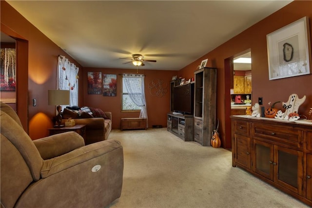 living room featuring ceiling fan and light carpet