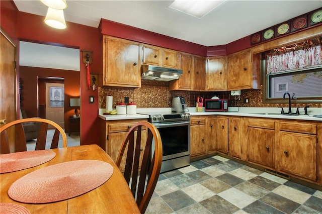 kitchen featuring appliances with stainless steel finishes, sink, and backsplash