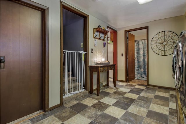 entryway featuring wooden walls