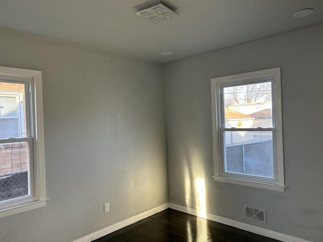 empty room featuring dark hardwood / wood-style flooring