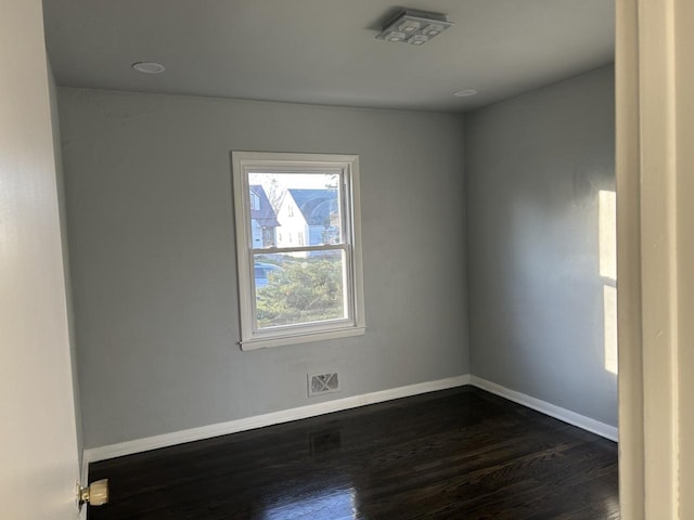 spare room with dark wood-type flooring