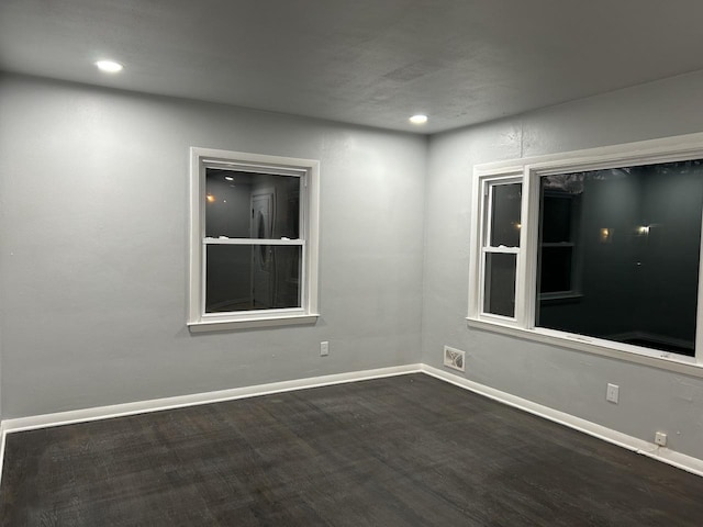 spare room with dark wood-type flooring