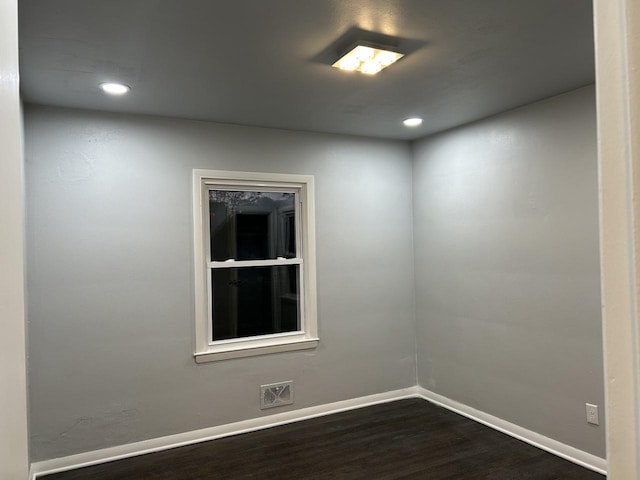 unfurnished room with dark hardwood / wood-style floors