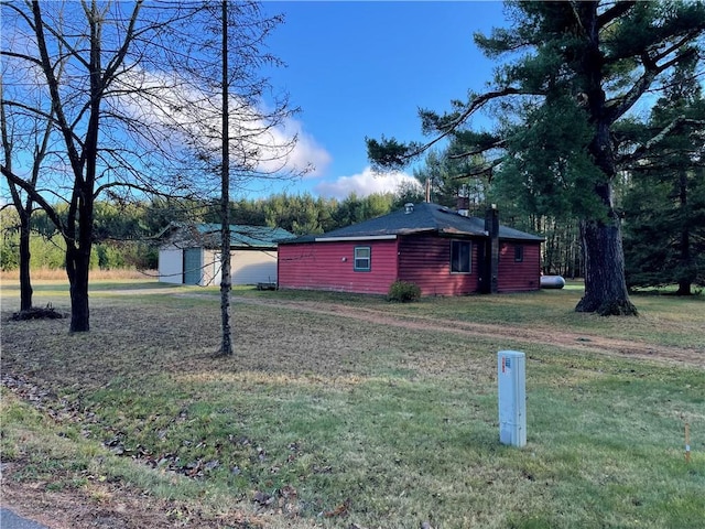 view of home's exterior featuring a storage shed and a yard