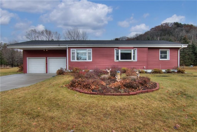 view of front facade featuring a garage, a lawn, and concrete driveway