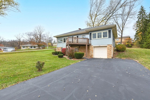 view of front of property with a garage, a front yard, and a wooden deck