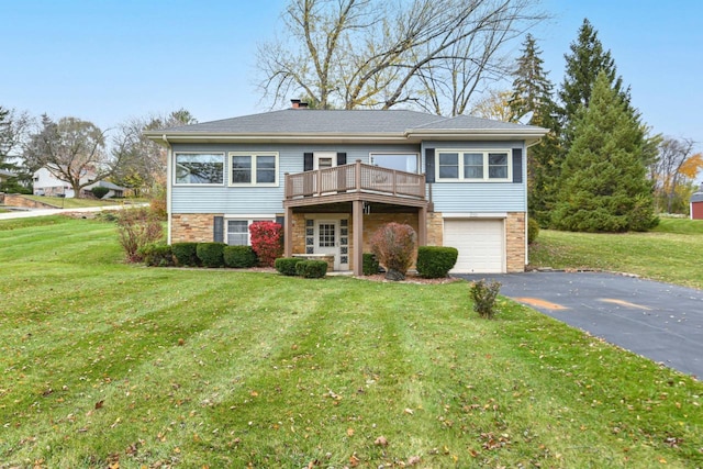 view of front of house featuring a front lawn, a garage, and a deck