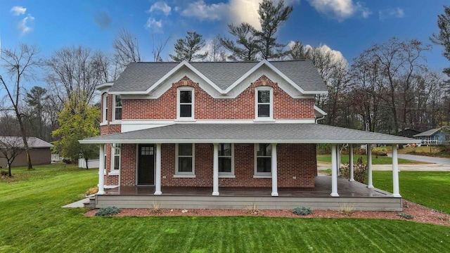 back of property with a lawn and covered porch