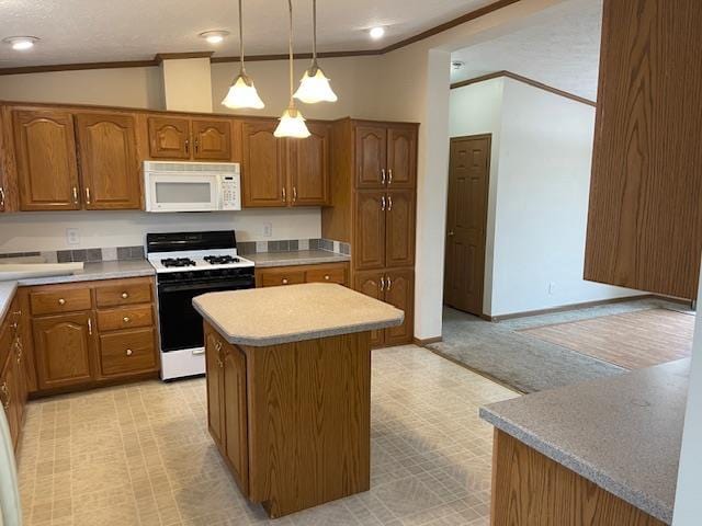 kitchen featuring lofted ceiling, hanging light fixtures, ornamental molding, a kitchen island, and white appliances