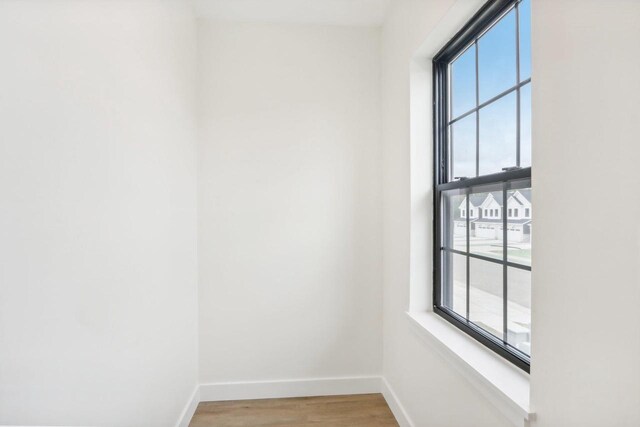 empty room featuring hardwood / wood-style flooring and a healthy amount of sunlight