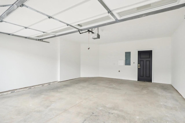 garage featuring electric panel and a garage door opener