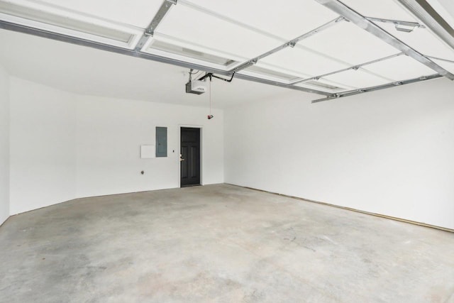 garage with electric panel and a garage door opener