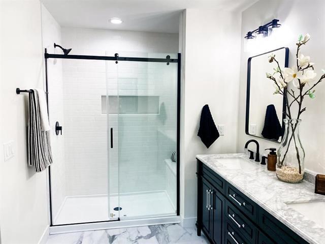 bathroom featuring vanity and walk in shower