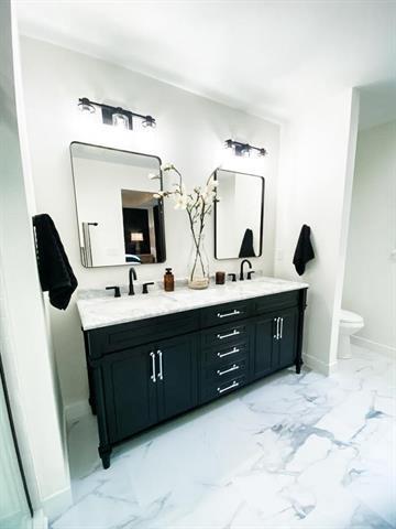 bathroom featuring vanity and toilet