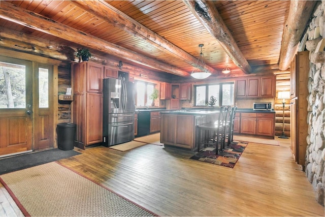 kitchen with a center island, light hardwood / wood-style flooring, wooden ceiling, beam ceiling, and appliances with stainless steel finishes