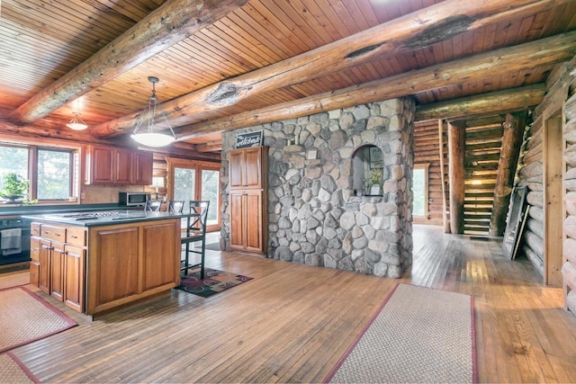 kitchen with dark wood-type flooring, a kitchen bar, wooden ceiling, and beam ceiling