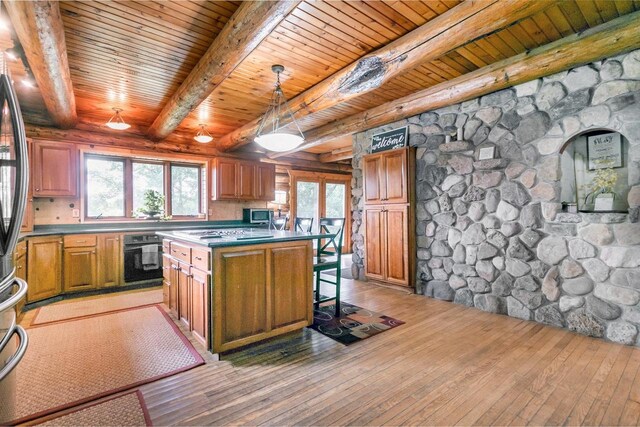 kitchen with black oven, a kitchen island, light wood-type flooring, hanging light fixtures, and wooden ceiling