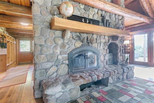 interior details with a fireplace, beam ceiling, hardwood / wood-style flooring, and wood ceiling