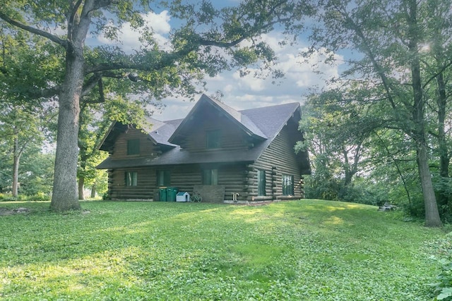 rear view of property featuring a lawn