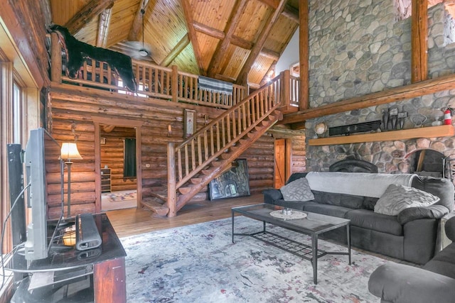 living room featuring wood-type flooring, a fireplace, rustic walls, high vaulted ceiling, and wood ceiling