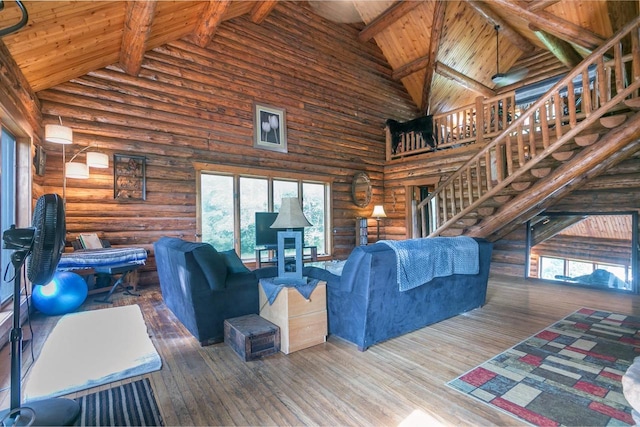 living room with beamed ceiling, high vaulted ceiling, hardwood / wood-style floors, wood ceiling, and log walls