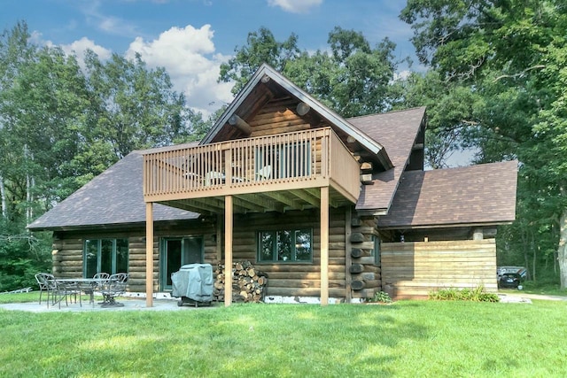 back of property featuring a lawn and a patio