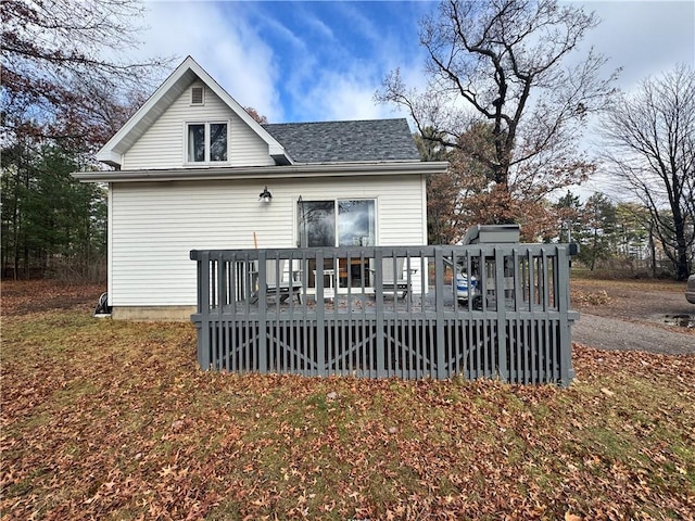 rear view of property with a wooden deck