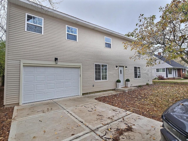 back of house with a garage