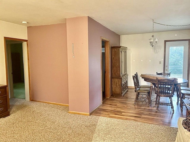 dining room featuring light hardwood / wood-style flooring and a chandelier