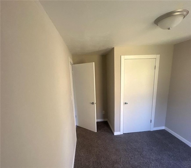 6970 Second St, Loretta, WI 54896 - unfurnished bedroom with dark colored carpet and baseboards