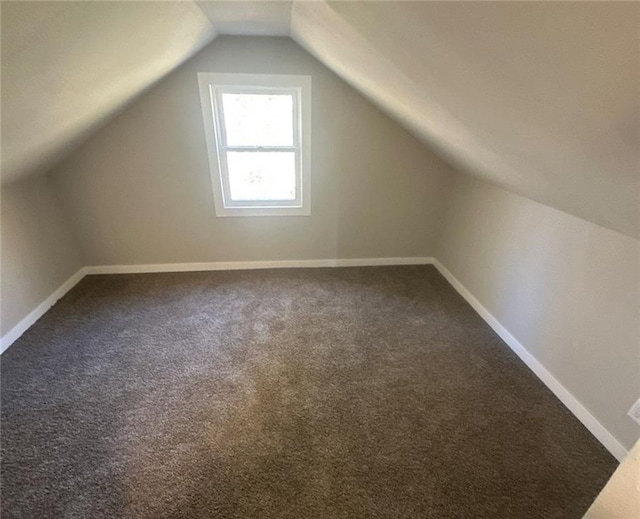 6970 Second St, Loretta, WI 54896 - bonus room with dark carpet, lofted ceiling, and baseboards
