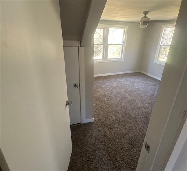 6970 Second St, Loretta, WI 54896 - unfurnished room featuring dark colored carpet, healthy amount of natural light, baseboards, and a ceiling fan