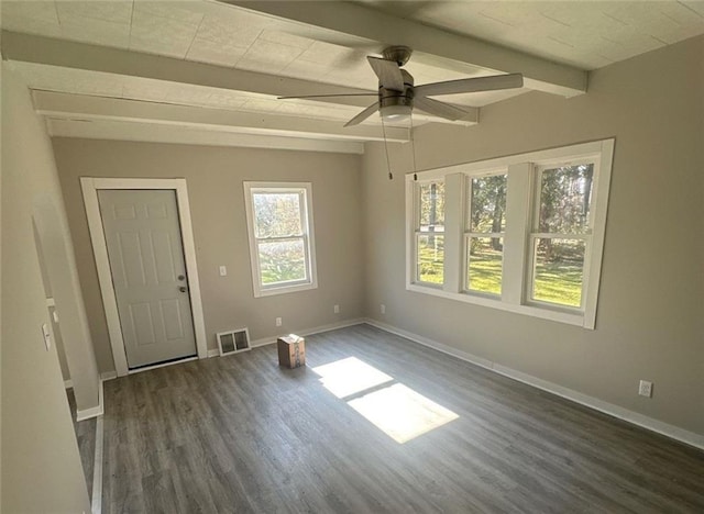 unfurnished room with dark wood-type flooring, ceiling fan, and beam ceiling