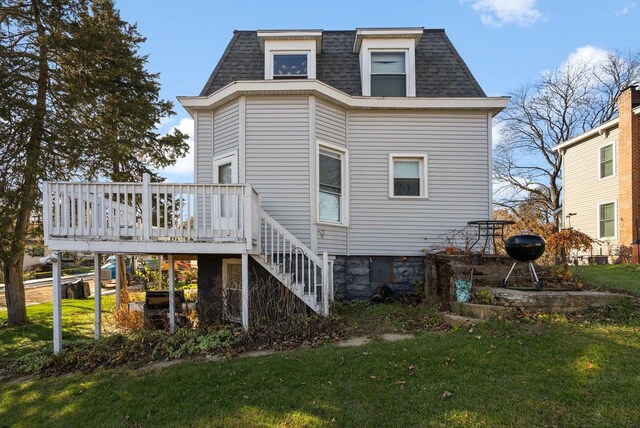 318 Mandt Pkwy, Stoughton, WI 53589 - back of house with roof with shingles, a wooden deck, mansard roof, and stairway