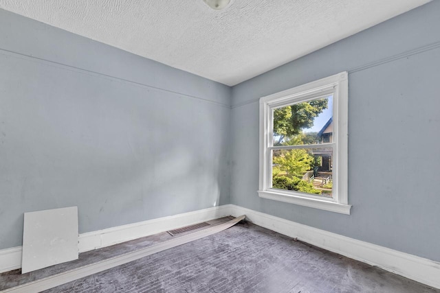 empty room featuring a textured ceiling