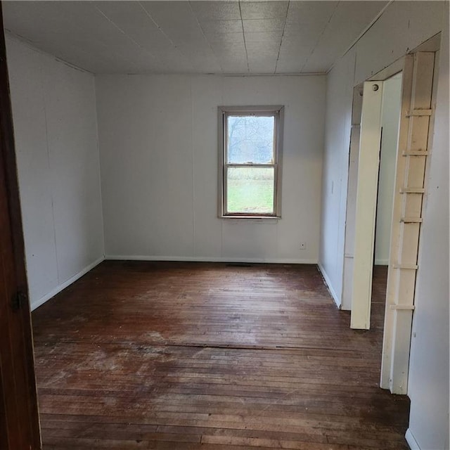 unfurnished room featuring dark hardwood / wood-style floors