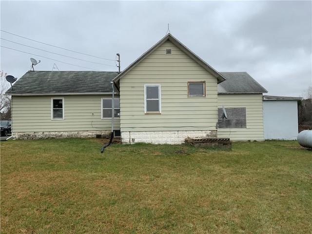 rear view of house featuring a lawn