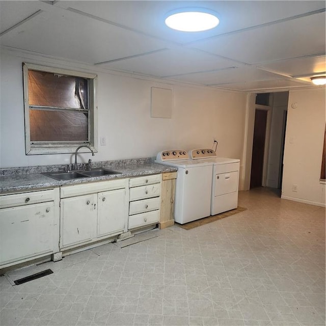 laundry area with washing machine and dryer and sink