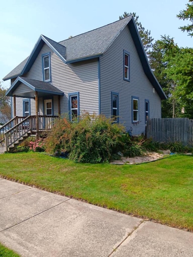 view of front facade with a porch and a front lawn