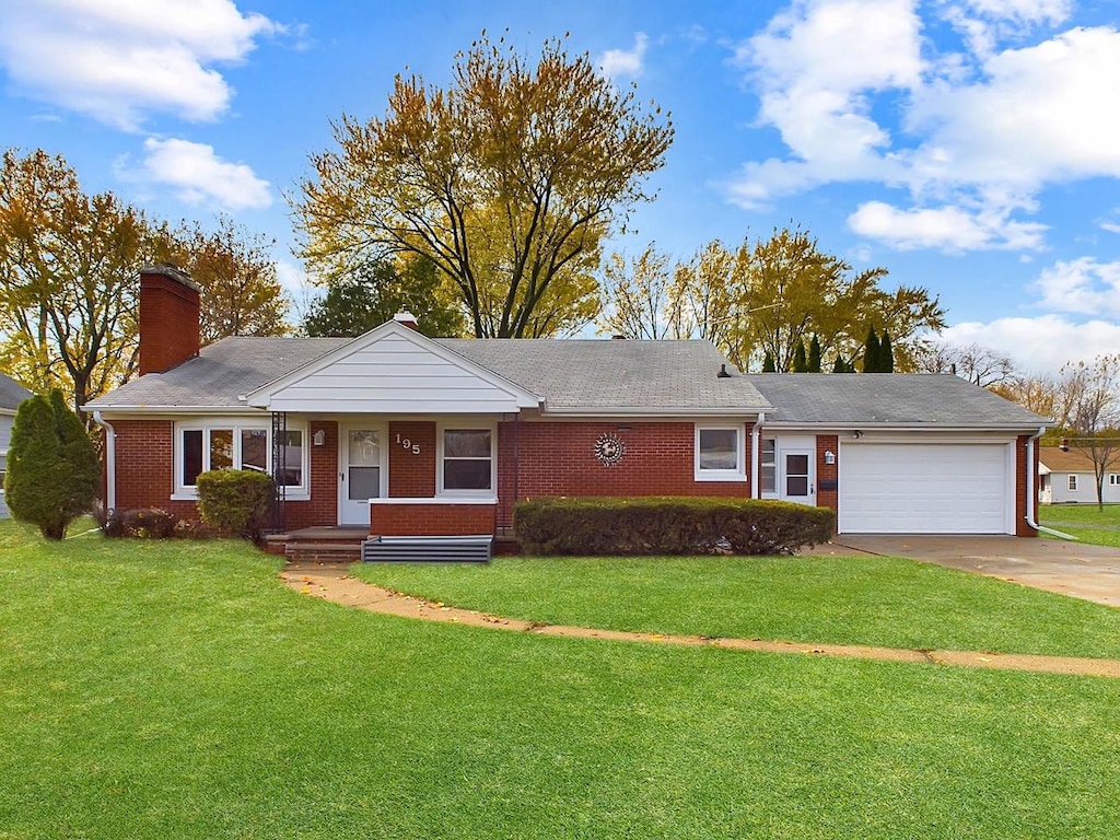 ranch-style house with a garage and a front yard