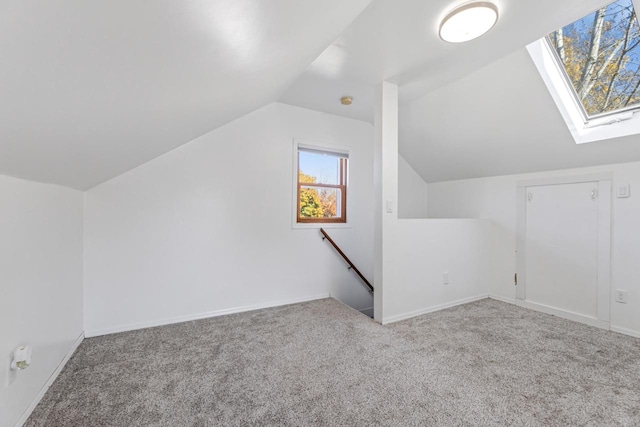 bonus room with light carpet and lofted ceiling with skylight