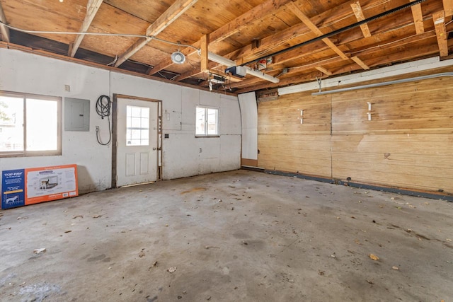 garage featuring a garage door opener and electric panel