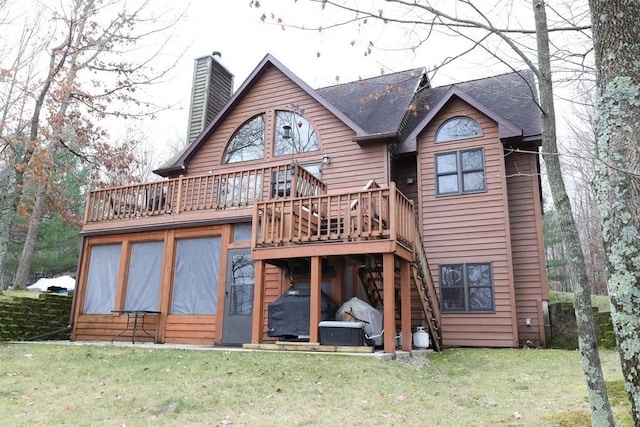 rear view of property with a lawn and a deck