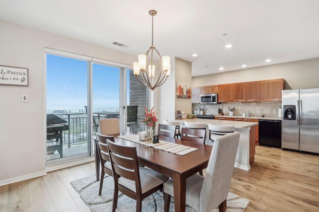 dining room featuring a chandelier and light hardwood / wood-style floors