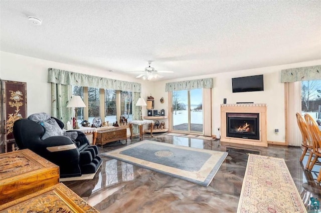 living room with a textured ceiling, a healthy amount of sunlight, and ceiling fan