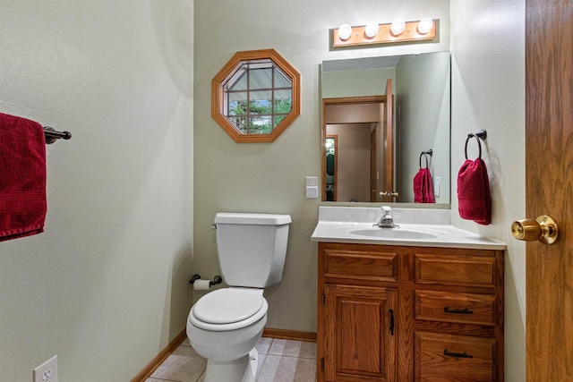 bathroom featuring vanity, tile patterned flooring, and toilet