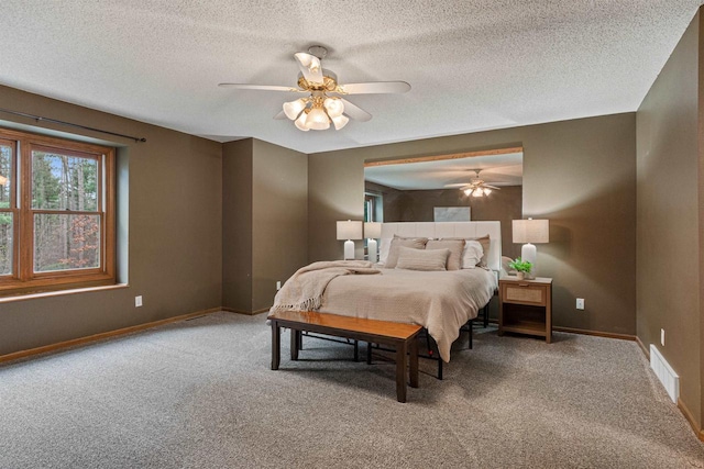 bedroom with carpet flooring, a textured ceiling, and ceiling fan