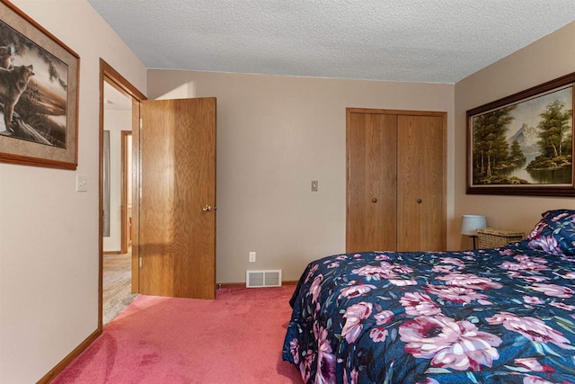 bedroom featuring light colored carpet, a textured ceiling, and a closet